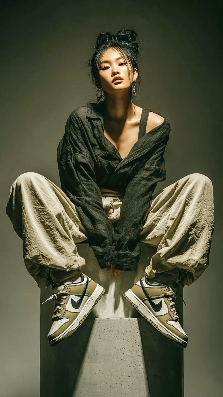 Photographer holding a camera to their face, taken in the studio