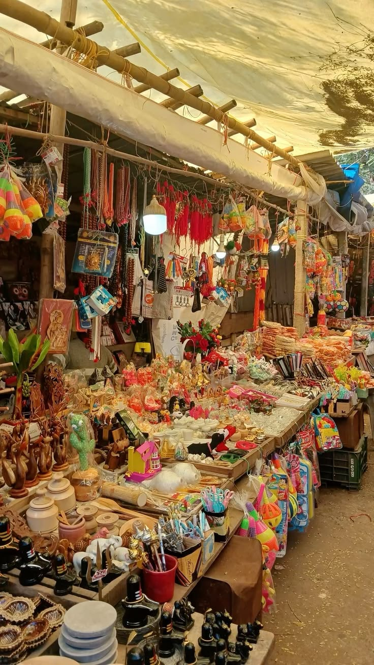 A densely packed bazaar stall at the Karachi port thrift market, hung with bags, trinkets and household goods